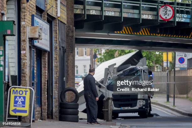 The damaged remains of a lorry near a scrap metal yard at Loughborough Junction after it crashed into one of the railway bridges - a main transport...