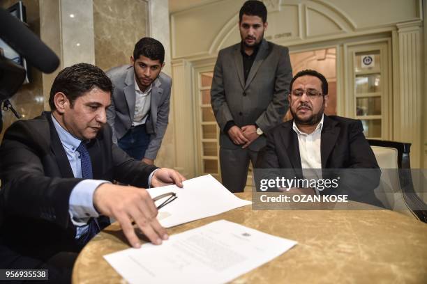 Letters in Arabic and English languages stay on the table as Libyan dissident Abdel Hakim Belhaj sit after a press conference on May 10 after...