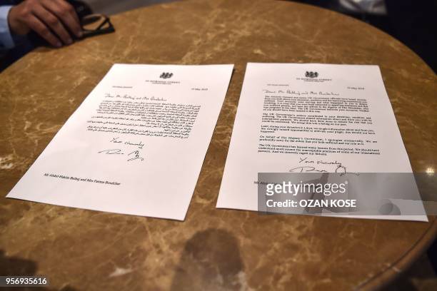 Letters in Arabic and English languages are pictured on the table as Libyan dissident Abdel Hakim Belhaj sits after a press conference on May 10...