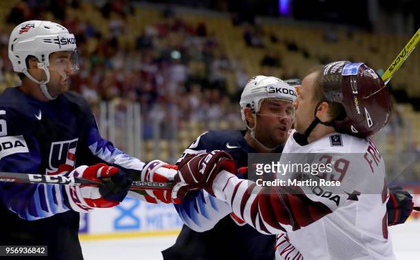 Alec Martinez of United States pushes Ralfs Freibergs of Latvia battle during the 2018 IIHF Ice Hockey World Championship Group B game between United...
