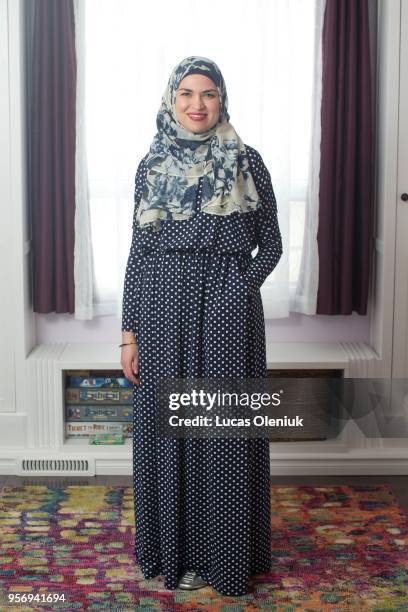 Columnist Uzma Jalaluddin poses in a formal dress for a black tie event inside her Markham home.