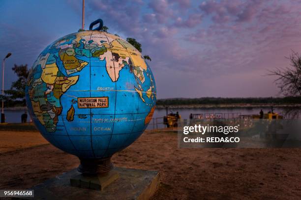 The Paraa Ferry during sunrise with vehicles tourists and locals waiting to be brought across the Victoria Nile. Murchison Falls national park....