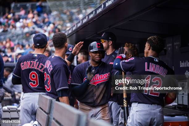 Rajai Davis of the Cleveland Indians gets greeted by his teammates after scoring a run during the game against the New York Yankees at Yankee Stadium...