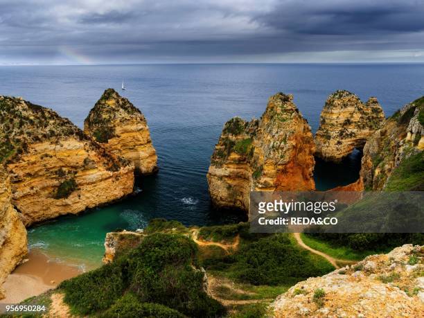 The cliffs and sea stacks of Ponta da Piedade at the rocky coast of the Algarve in Portugal. Europe. Southern Europe. Portugal. March.