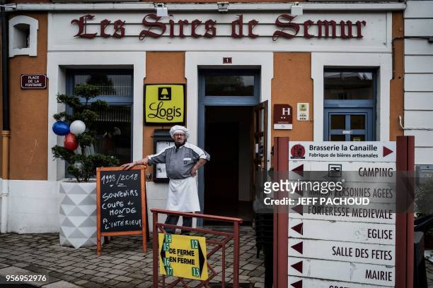 Chef is pictured in front of his hotel restaurant decorated with blue, white and red balloons, on May 10, 2018 in Sail-sous-Couzan, western France,...