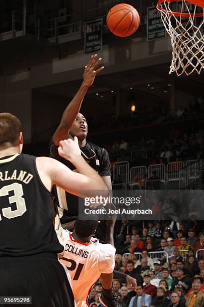Al-Farouq Aminu of the Wake Forest Demon Deacons gets an offensive foul as he goes to the basket against Dwayne Collins of the Miami Hurricanes on...