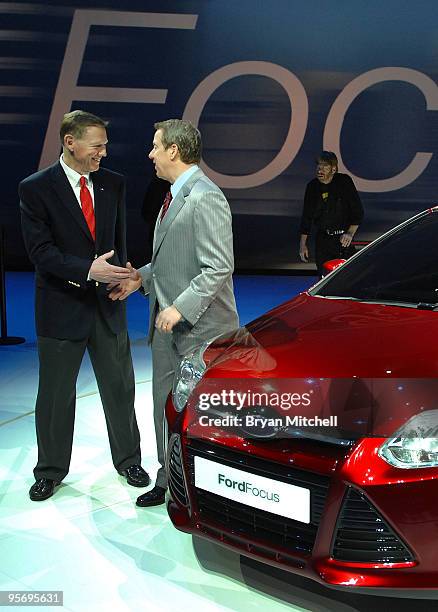 Alan Mulally, President and CEO Ford Motor Company, and William Clay Ford Jr., Executive Chairman Ford Motor Company shake hands after posing for...