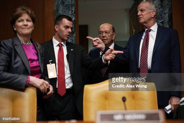 Secretary of Commerce Wilbur Ross , subcommittee chairman Sen. Jerry Moran and ranking member Jeanne Shaheen arrive at a hearing before the Commerce,...
