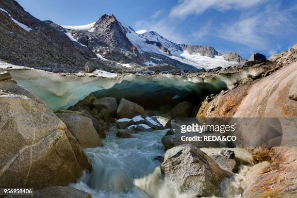 The glacier snout with ice cave of Viltragenkees in the National Park Hohen Tauern. Viltragenkees is showing signs of rapid retreat. Its snout is...