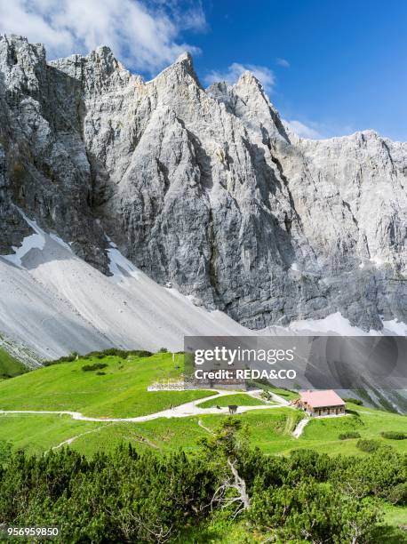 Karwendel Mountain Range. The peaks towards Mt. Bockkar-Spitze and the mountain hut Falkenhuette. Austria. The mountain hut Falkenhuette is a popular...