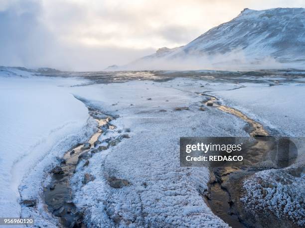 Geothermal area Hveraroend near lake Myvatn and the ring road during winter with mud pools . Fumaroles and solfataras. Europe. Northern Europe....