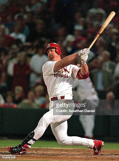 Mark McGwire of the St. Louis Cardinals hits the ball during the game against the Houston Astros at Busch Stadium in St. Louis, Missouri. According...