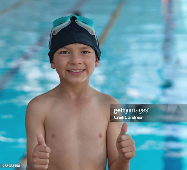 latin american happy boy with thumbs up looking at camera smiling - boy swimming pool goggle and cap stock pictures, royalty-free photos & images