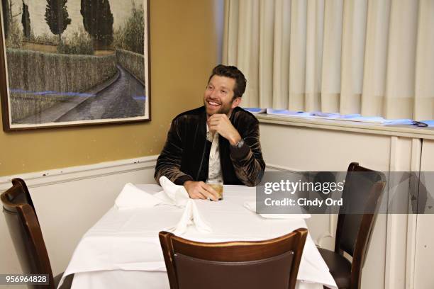 Brett Eldredge sits at Frank Sinatra's favorite table after performing on SiriusXM's The Highway channel at Patsy's Italian Restaurant on May 7, 2018...