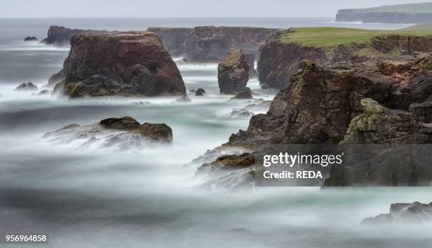 Landscape on the Eshaness peninsula. The famous cliffs and sea stacks of Eshness. A major attraction on the Shetland Islands. The cliffs are a major...