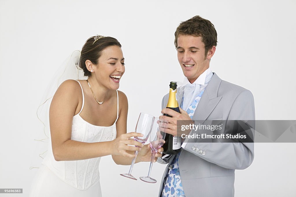 Newlyweds with bottle of champagne