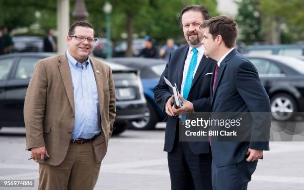 From left, Rep. Tom Garrett, R-Va., former Deputy Assistant to the President Sebastian Gorka, and Rep. Matt Gaetz, R-Fla., talk outside of the...