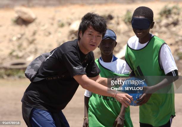 Volunteer Kouhei Kurihara teaches children blind football at the CFPT Center for Technical and Vocational Training Senegal Japan, during the national...