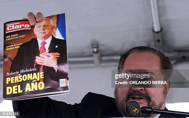 Honduran businessman Adolfo Facusse speaks and holds up a magazine portraying defacto Honduran President, Roberto Micheletti, as "Person of the Year"...