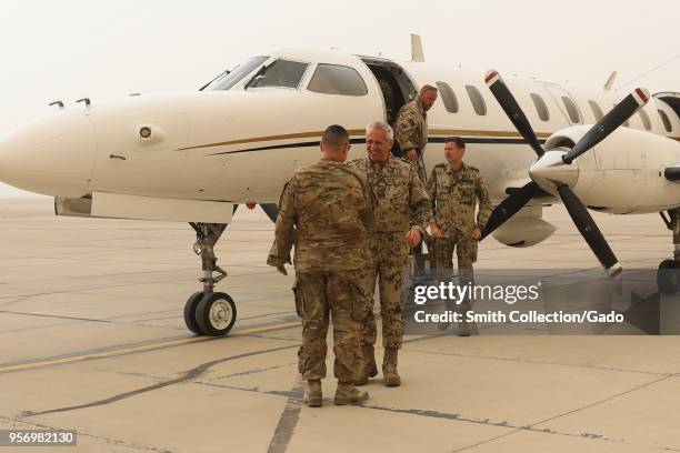 Photograph of US army Brigadier General John Lathrop greeting German army Lieutenant General Johann Langenegger at Kandahar Airfield, Afghanistan,...