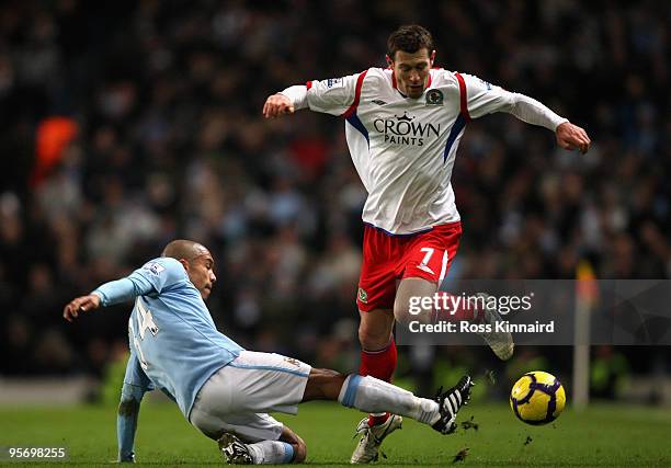 Nigel de Jong of Manchester City tackles Brett Emerton of Blackburn Rovers during the Barclays Premier League match between Manchester City and...