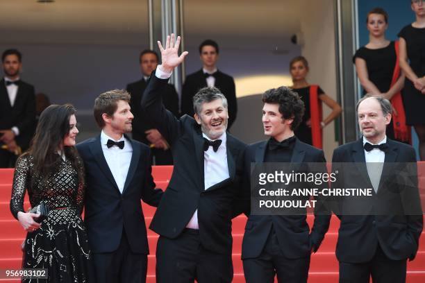 French director Christophe Honore waves as he arrives with French actress Adele Wismes, French actor Pierre Deladonchamps, French actor Vincent...