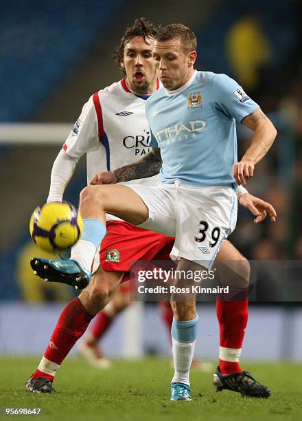 Craig Bellamy of Manchester City is pressurised by Gael Givet of Blackburn Rovers during the Barclays Premier League match between Manchester City...