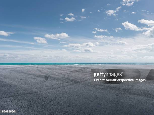 asphalt road in front of sea - miami sky stock pictures, royalty-free photos & images