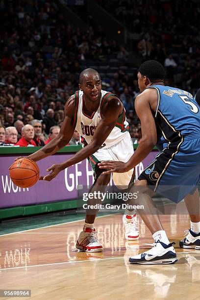 Luc Mbah a Moute of the Milwaukee Bucks looks to make a move against Dominic McGuire of the Washington Wizards during the game at the Bradley Center...