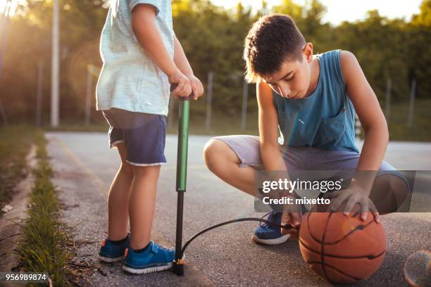 children inflating the ball - inflating stock pictures, royalty-free photos & images