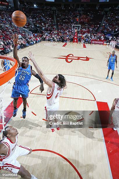 Jeff Green of the Oklahoma City Thunder hooks a shot over Luis Scola of the Houston Rockets during the game on December 19, 2009 at the Toyota Center...