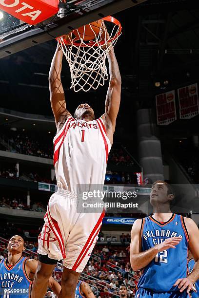 Trevor Ariza of the Houston Rockets dunks the ball against Nenad Krstic of the Oklahoma City Thunder during the game on December 19, 2009 at the...