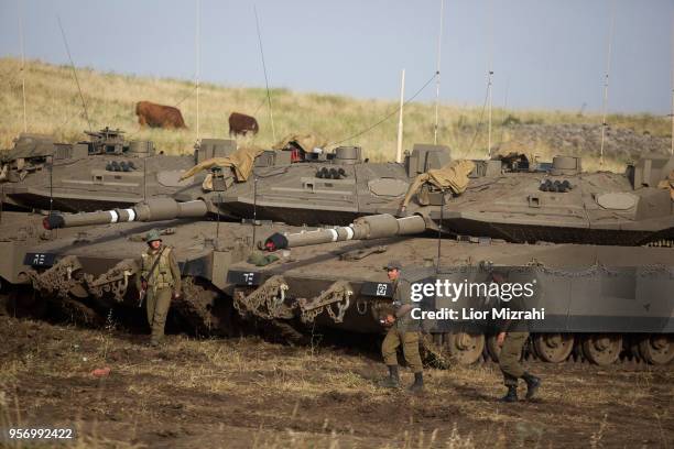 Israeli Soldiers are seen next to Merkava tanks deployed near the Israeli-Syrian border on May 10, 2018in the Israeli-annexed Golan Heights. Some 20...