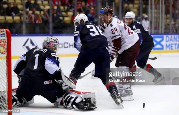 Keith Kinkaid , goaltender of United States makes a save on Mikelis Redlihs of Latvia during the 2018 IIHF Ice Hockey World Championship Group B game...