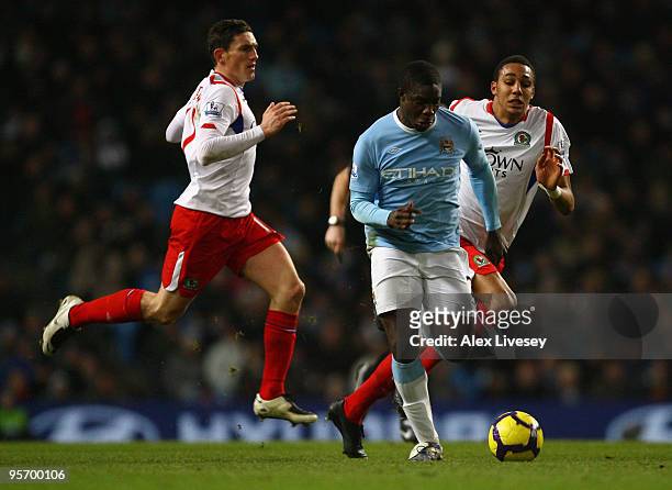 Micah Richards of Manchester City breaks clear of Steven N'Zonzi and Keith Andrews of Blackburn Rovers on his way to scoring the second goal during...