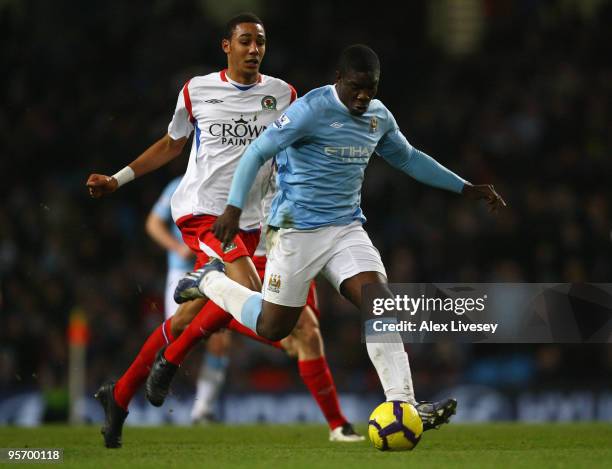 Micah Richards of Manchester City breaks clear of Steven N'Zonzi of Blackburn Rovers on his way to scoring the second goal during the Barclays...