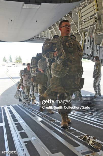 Photograph of soldiers from the 201st Expeditionary Military Intelligence Brigade boarding a C-17 Globemaster III transport aircraft during a field...