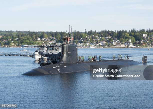 Photograph of submariners standing on top of the Seawolf-class fast-attack submarine USS Connecticut in the water at Naval Base Kitsap-Bremerton,...