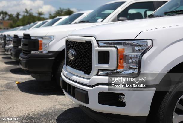 Ford F-150 pickup trucks are seen on a sales lot on May 10, 2018 in Miami, Florida. The company announced it is suspending production of its F-150...