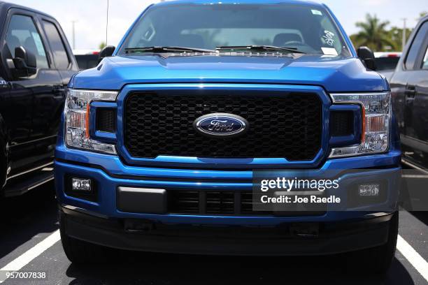 Ford F-150 pickup trucks are seen on a sales lot on May 10, 2018 in Miami, Florida. The company announced it is suspending production of its F-150...