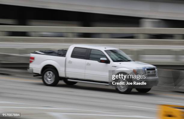 Ford F-150 pickup truck is seen being driven along a road on May 10, 2018 in Miami, Florida. The company announced it is suspending production of its...