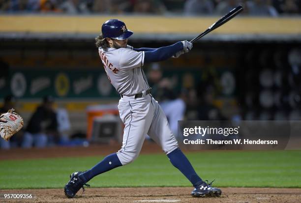 Jake Marisnick of the Houston Astros hits a double against the Oakland Athletics in the top of the fifth inning at the Oakland Alameda Coliseum on...