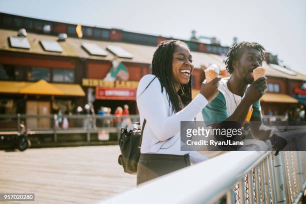 couple enjoying ice cream on seattle pier - seattle stock pictures, royalty-free photos & images