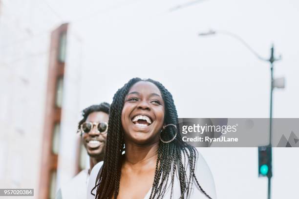young couple having fun in downtown seattle together - african ethnicity friends stock pictures, royalty-free photos & images