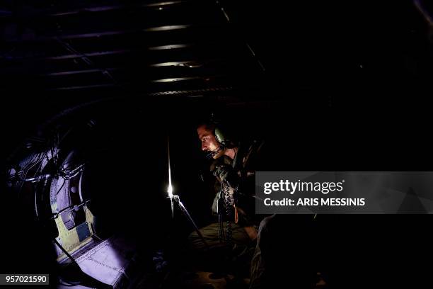 Crew member of the 330 meters aircraft carrier Harry S Truman works inside a transport airplane on eastern Mediterranean Sea on May 8, 2018. -...