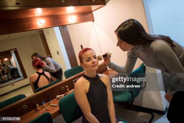 beautiful ballerina sitting at the dressing room and professional make up artist putting blush on her face - theatre dressing room stock pictures, royalty-free photos & images