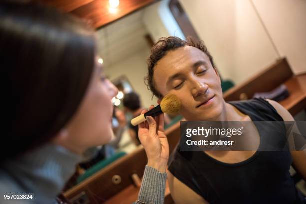professional make up artist applying make up on a male ballet performer - theatre dressing room stock pictures, royalty-free photos & images