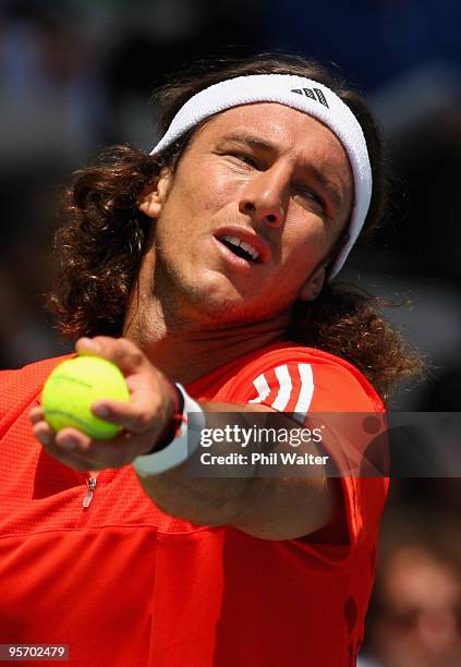 Juan Monaco of Argentina plays a backhand in his first round match against Horacio Zeballos of Argentina during day two of the Heineken Open at the...