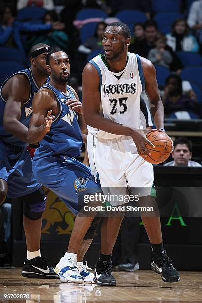 Al Jefferson of the Minnesota Timberwolves moves the ball against Gilbert Arenas of the Washington Wizards during the game on December 26, 2009 at...
