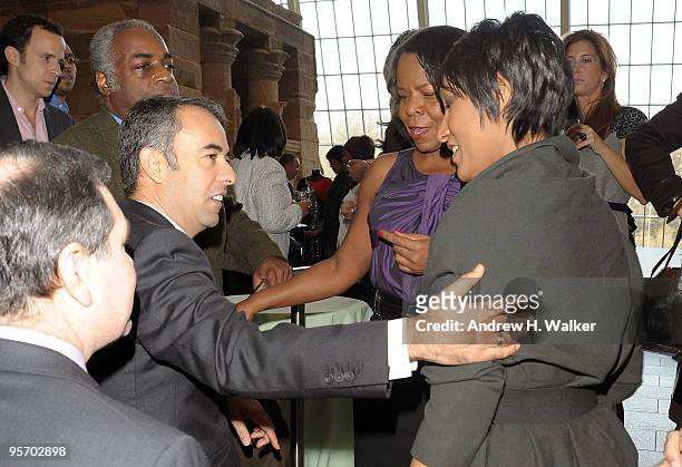 Fashion designers Francisco Costa and Geoffrey Banks talk with Desiree Rogers at the Eunice Johnson tribute luncheon at The Metropolitan Museum of...
